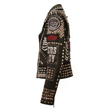 Side profile of the left arm of a black leather motorcycle jacket showcasing punk patches, skull graphics, and dense pyramid studs on the lower sleeve.